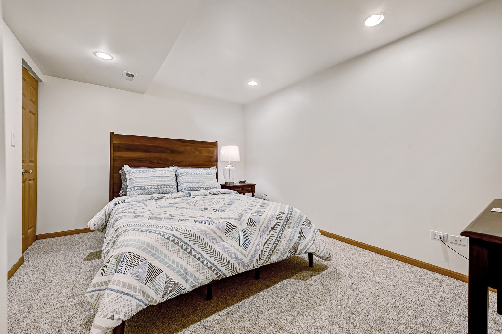 61 Berkshire Court Burr Ridge, IL 60527 - Photo 29 of 47 a bedroom with a bed and a night stand