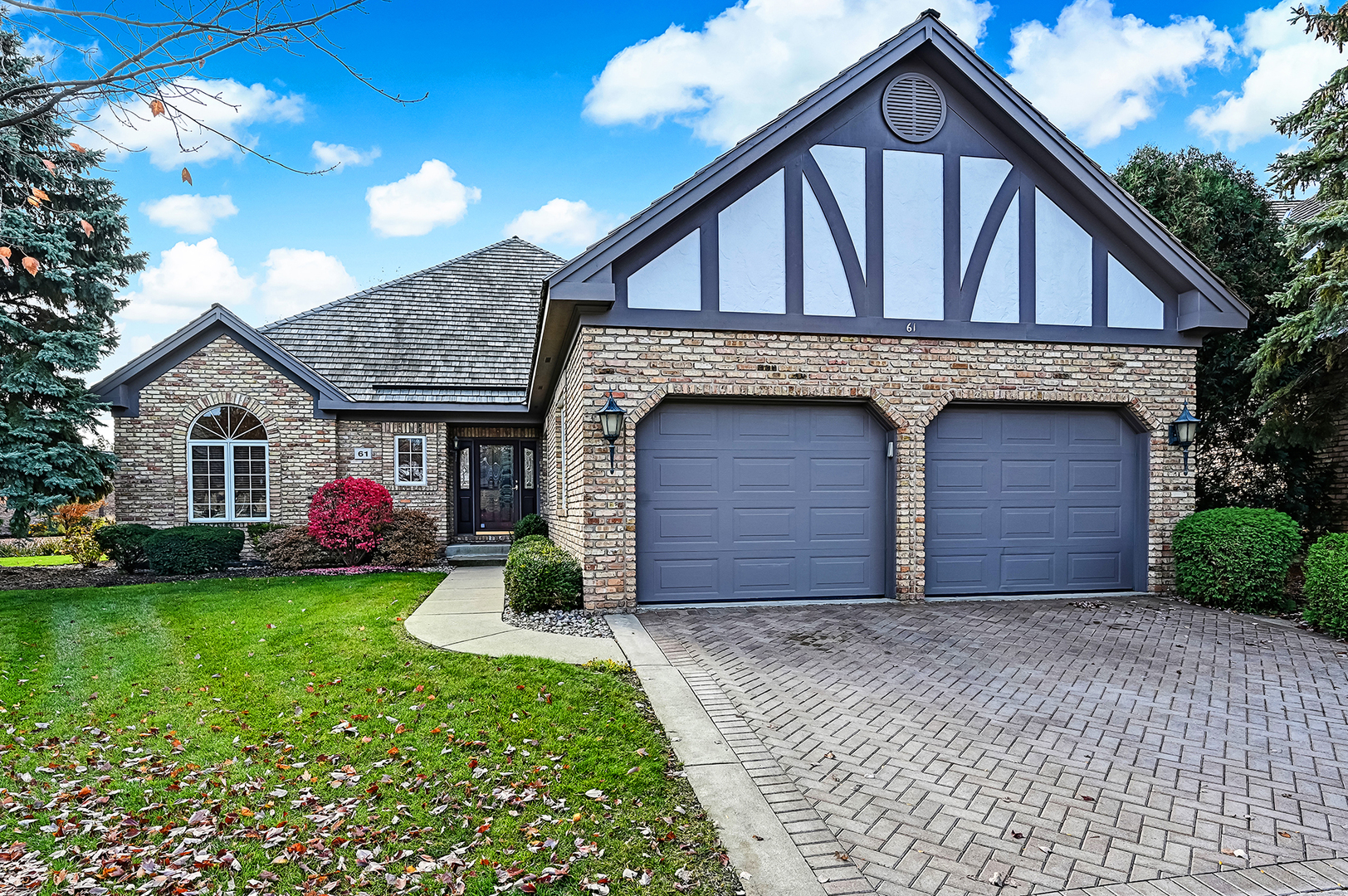 61 Berkshire Court Burr Ridge, IL 60527 - Photo 36 of 47 a front view of a house with a yard and garage