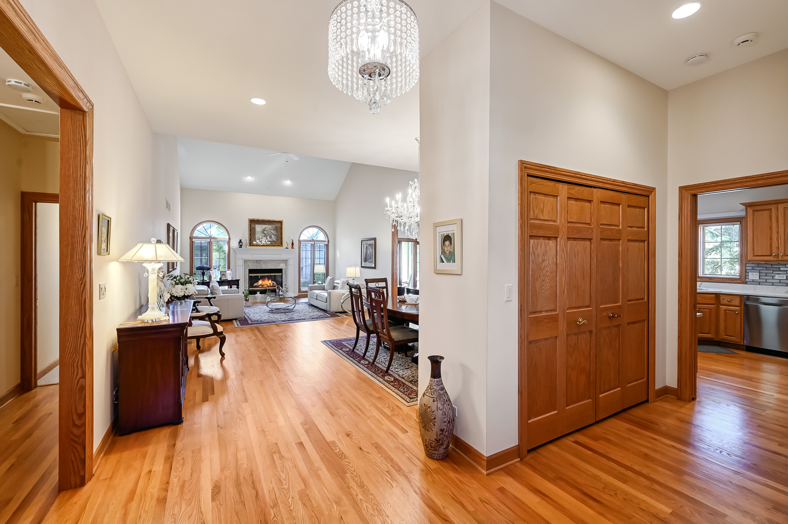 61 Berkshire Court Burr Ridge, IL 60527 - Photo 5 of 47 a view of a dining room kitchen with furniture a chandelier and wooden floor