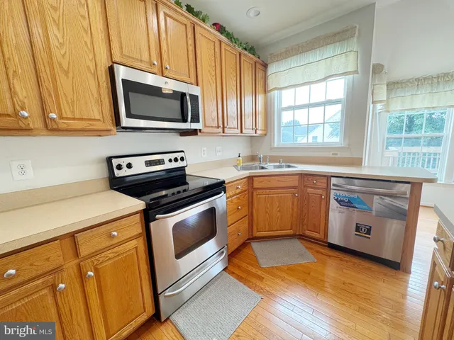 a kitchen with a sink stove and microwave