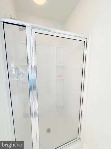 a bathroom with a glass shower door