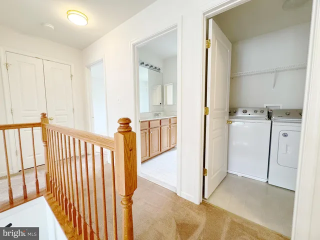 a view of a hallway with washer and dryer
