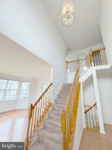 a view of staircase with railing and white walls