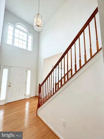 a view of staircase with railing and wooden floor