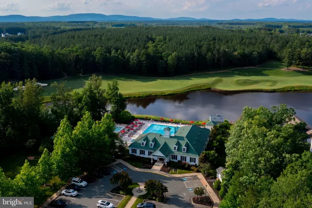 an aerial view of a house with pool yard and outdoor seating