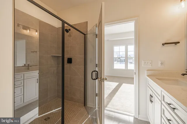 a bathroom with a tub shower vanity and a sink