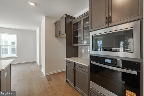 a kitchen with granite countertop a stove and a microwave