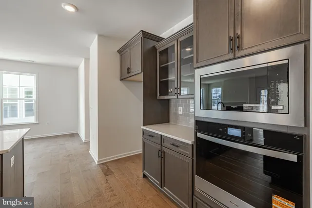 a kitchen with granite countertop a stove and a microwave