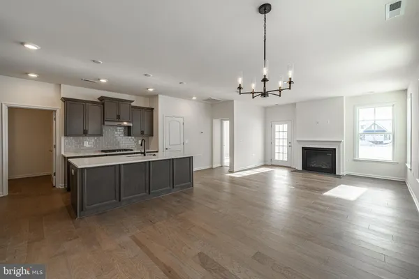 a view of a kitchen with a sink and a fireplace
