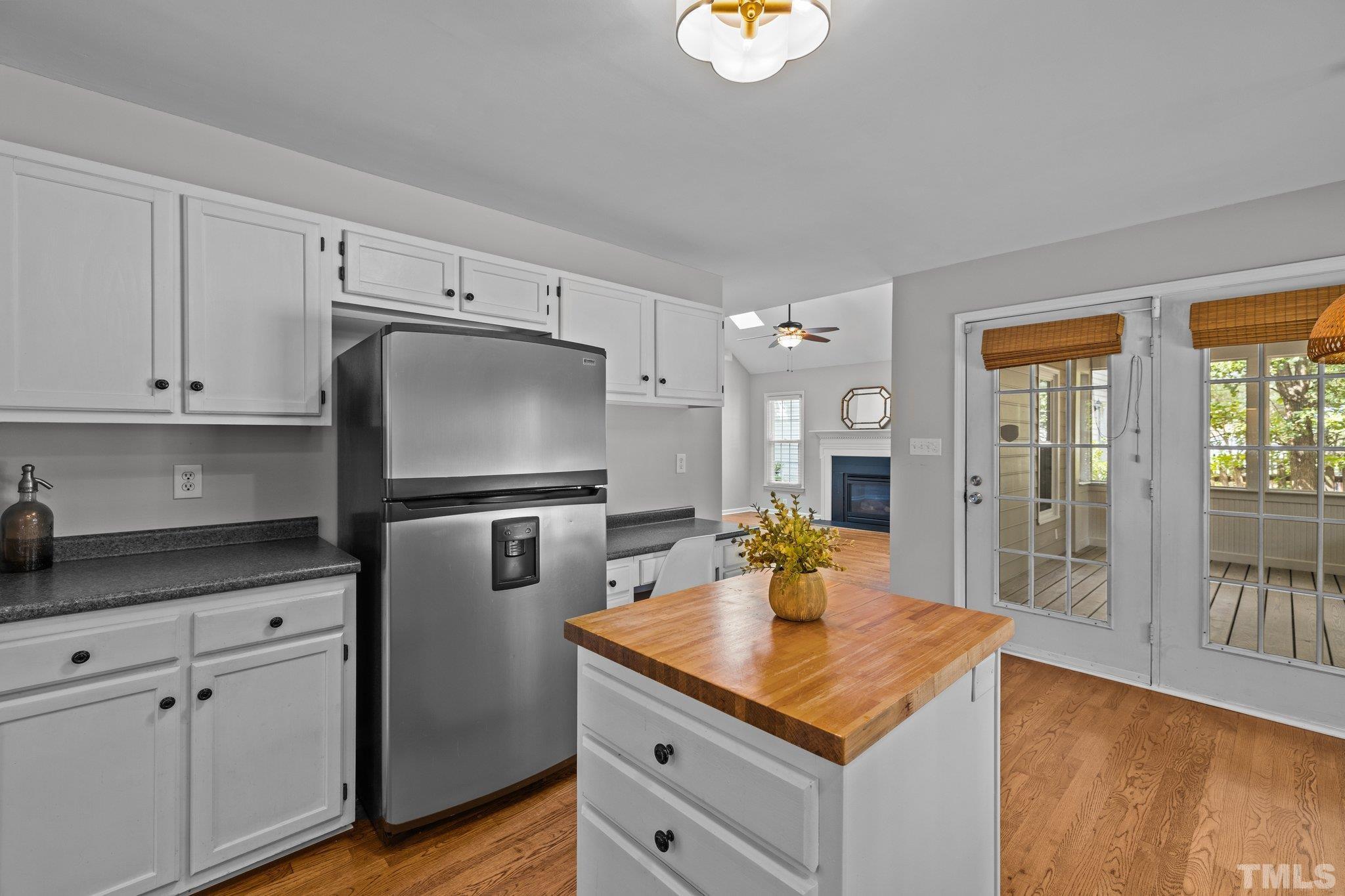 12028 North Exeter Way Raleigh, NC 27613 - Photo 17 of 48 a kitchen with stainless steel appliances cabinets and wooden floor