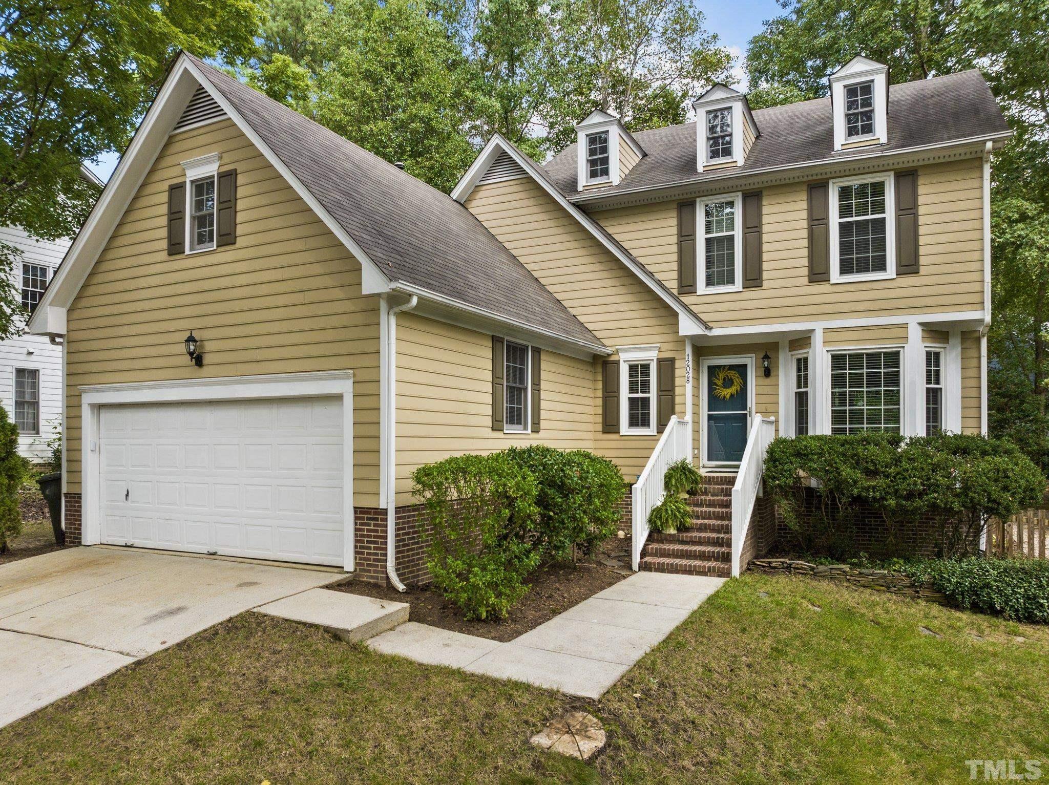 12028 North Exeter Way Raleigh, NC 27613 - Photo 2 of 48 a view of a house with a yard and plants