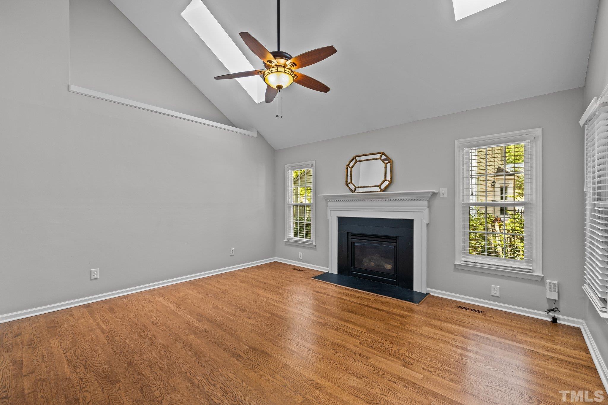 12028 North Exeter Way Raleigh, NC 27613 - Photo 21 of 48 an empty room with windows and fireplace