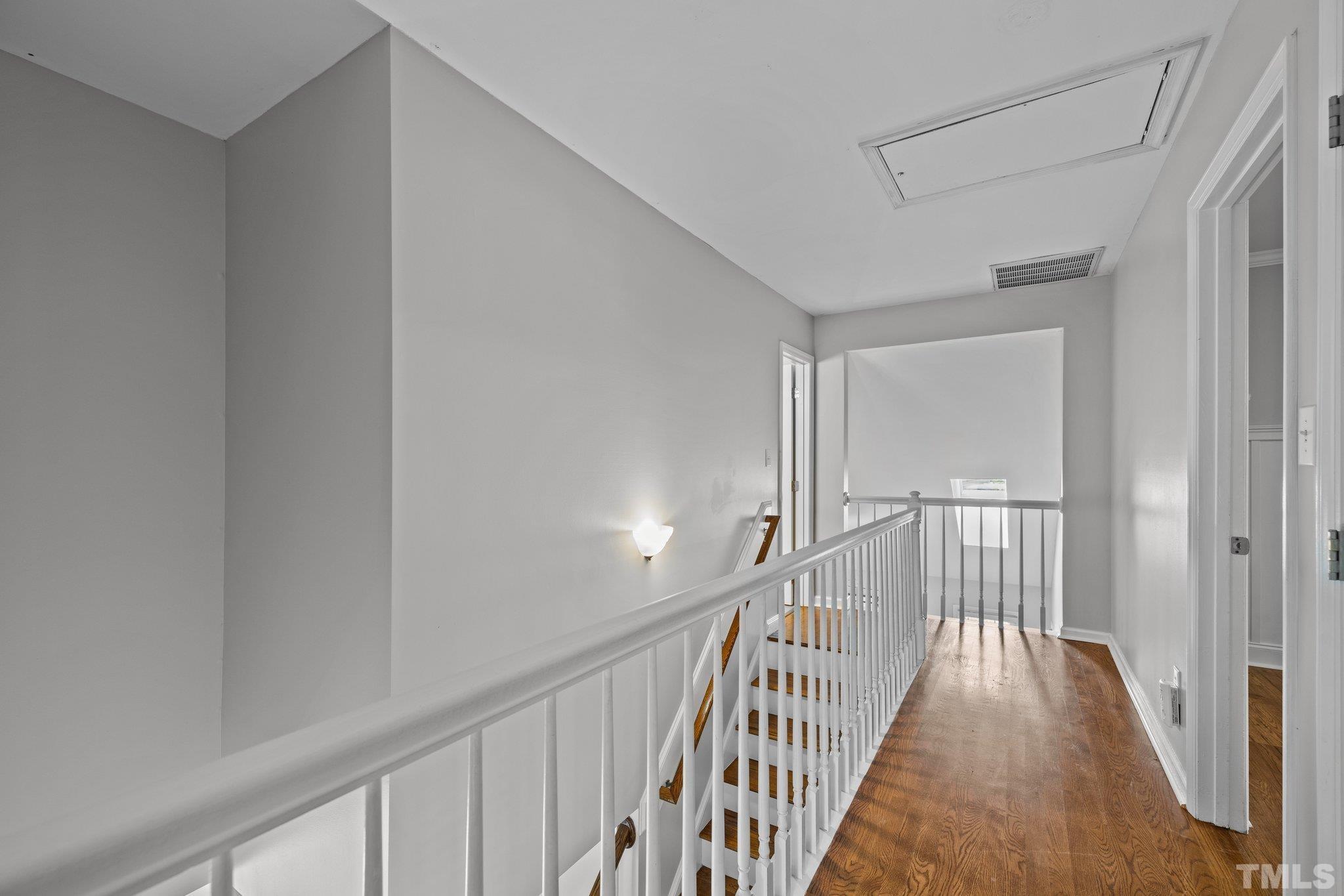 12028 North Exeter Way Raleigh, NC 27613 - Photo 27 of 48 a view of a hallway with wooden floor and staircase
