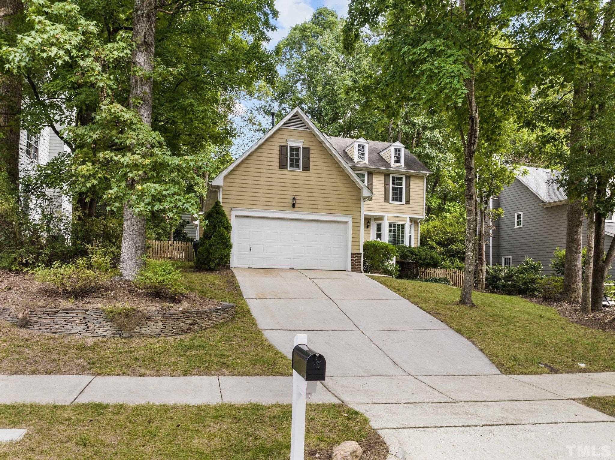 12028 North Exeter Way Raleigh, NC 27613 - Photo 3 of 48 a front view of a house with garden