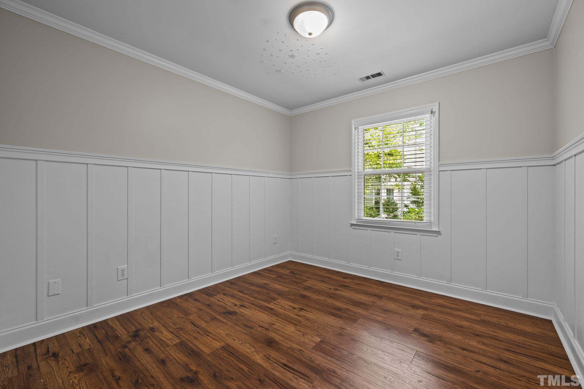 12028 North Exeter Way Raleigh, NC 27613 - Photo 33 of 48 an empty room with wooden floor and windows