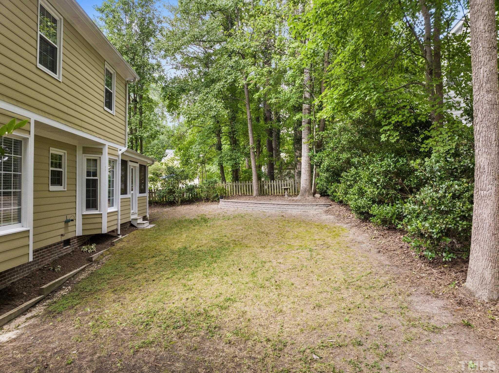 12028 North Exeter Way Raleigh, NC 27613 - Photo 40 of 48 a view of a house with backyard and trees