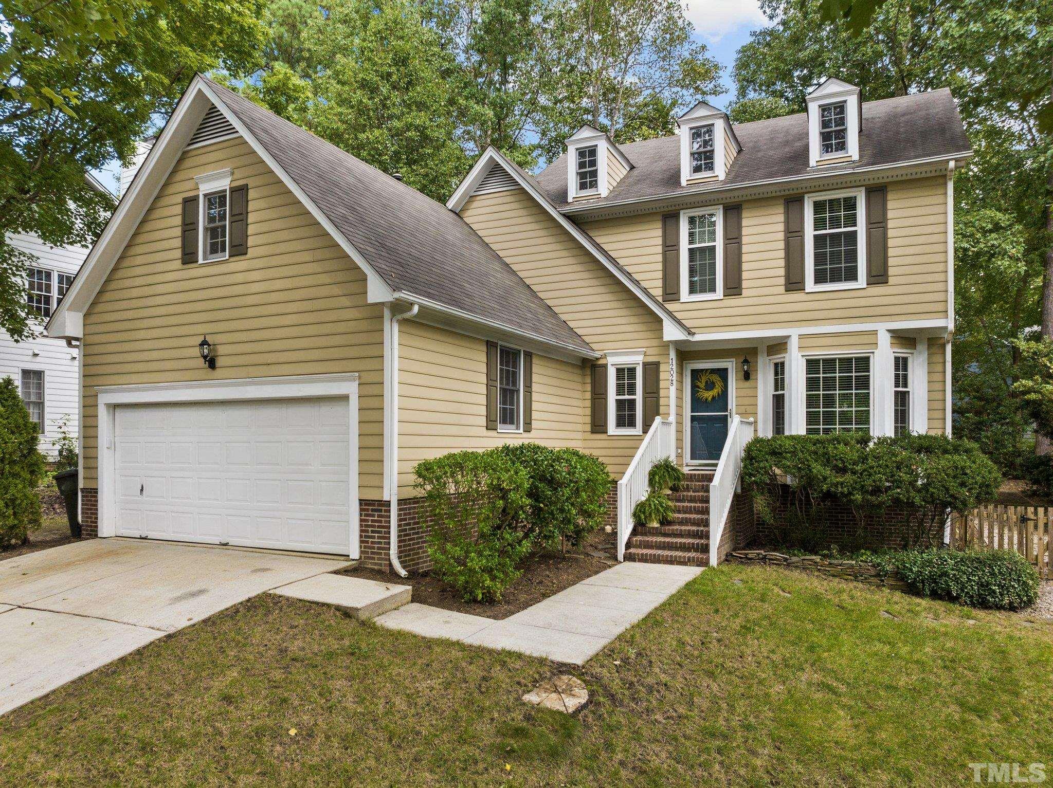 12028 North Exeter Way Raleigh, NC 27613 - Photo 4 of 48 a front view of a house with a garden