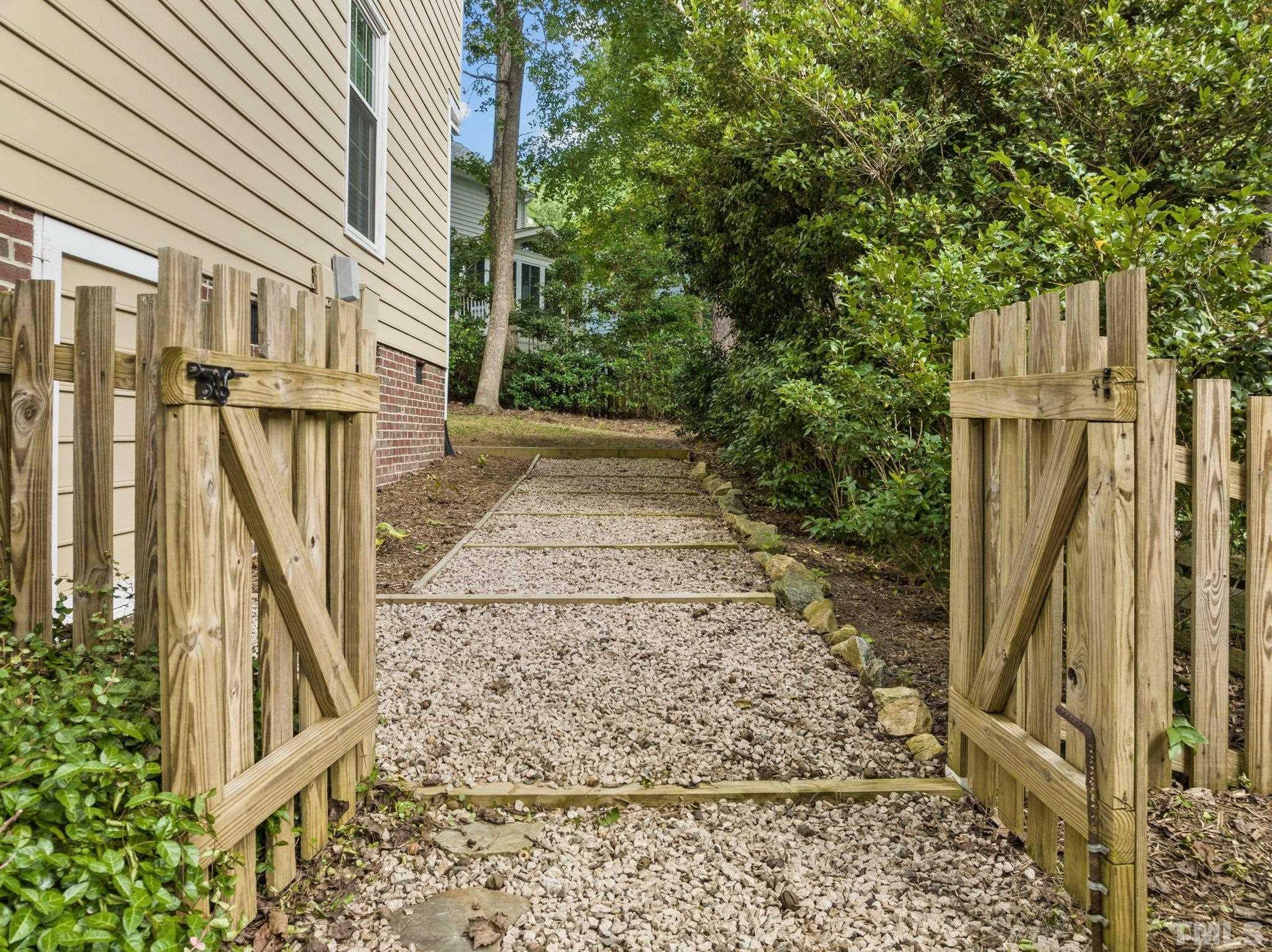 12028 North Exeter Way Raleigh, NC 27613 - Photo 43 of 48 a view of a pathway of a house with backyard