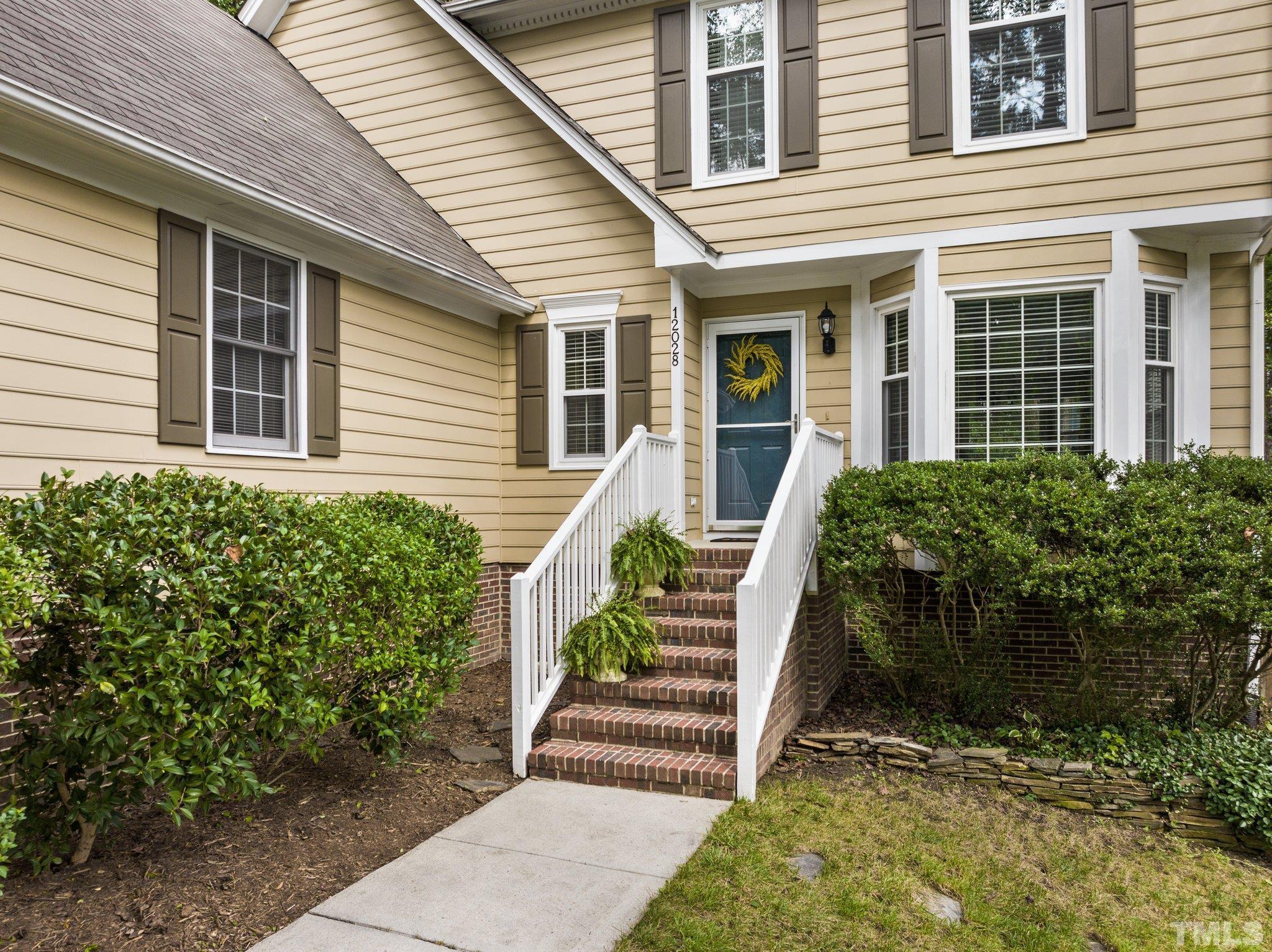 12028 North Exeter Way Raleigh, NC 27613 - Photo 6 of 48 a front view of a house with a porch