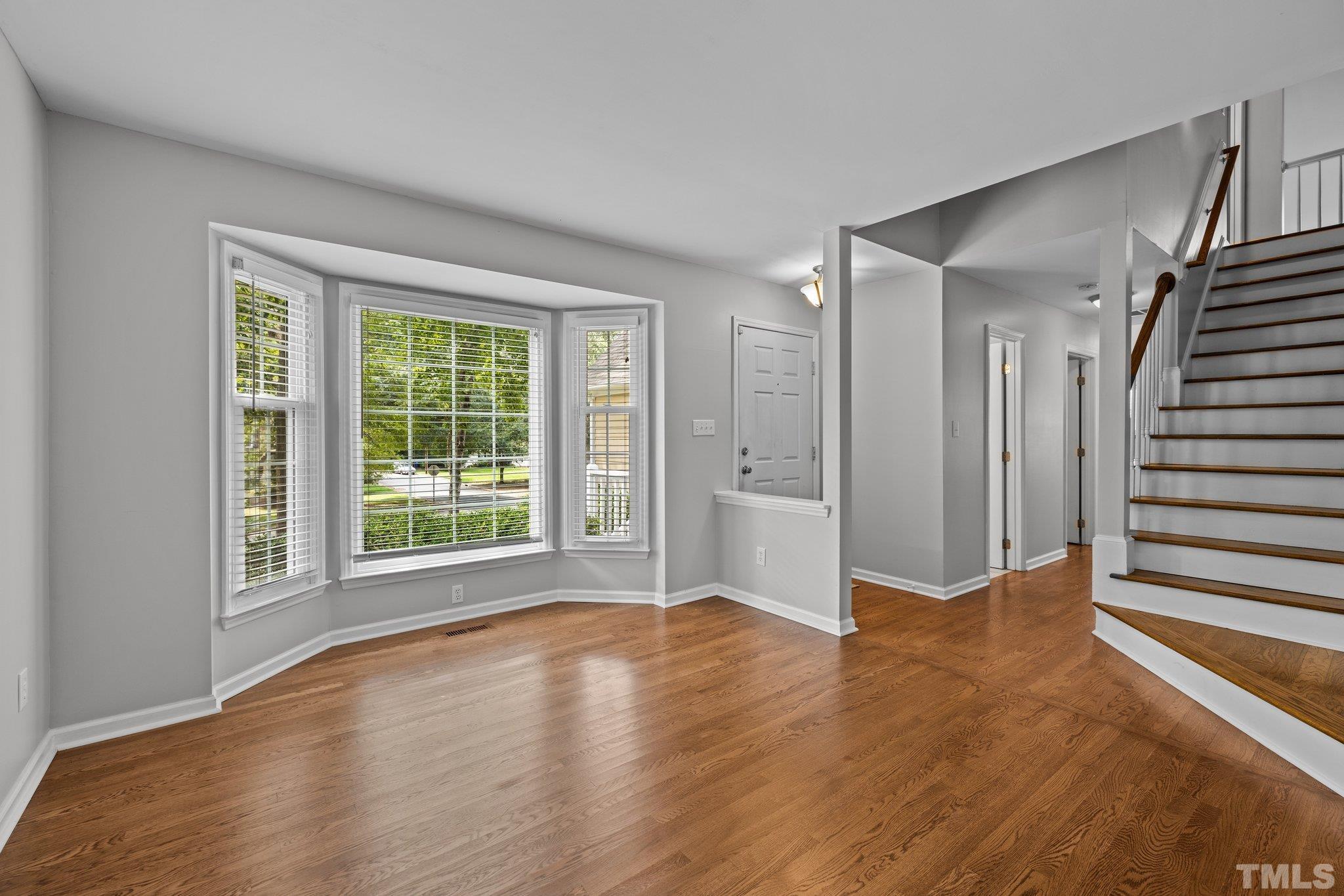 12028 North Exeter Way Raleigh, NC 27613 - Photo 8 of 48 a view of a livingroom with wooden floor and entryway
