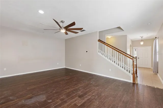 a view of an empty room with wooden floor