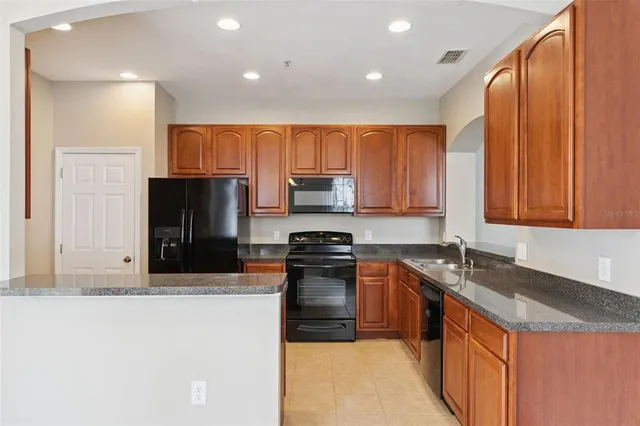 a kitchen with a sink stove and refrigerator