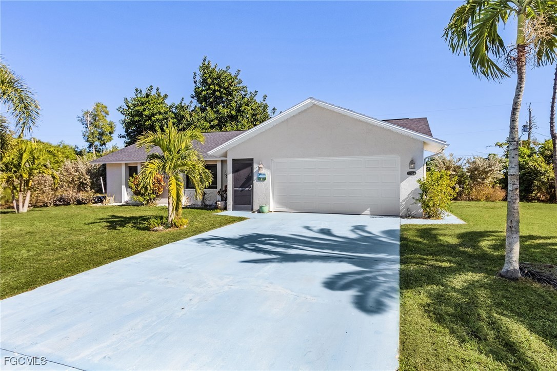 12184 Dolphin Road Bokeelia, FL 33922 - Photo 3 of 25 a front view of a house with garden