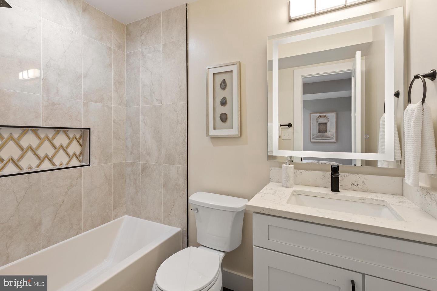 213 Bates Street Northwest, Unit 1 Washington, DC 20001 - Photo 19 of 28 a bathroom with a sink toilet and shower