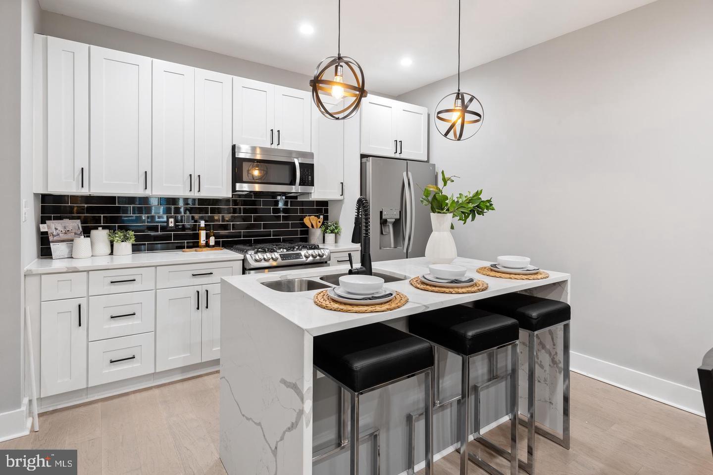 213 Bates Street Northwest, Unit 1 Washington, DC 20001 - Photo 2 of 28 a kitchen with stainless steel appliances kitchen island granite countertop a sink and cabinets