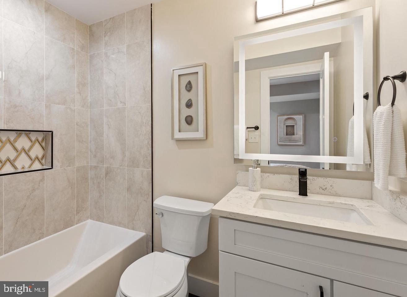 213 Bates Street Northwest, Unit 1 Washington, DC 20001 - Photo 26 of 28 a bathroom with a sink toilet and shower