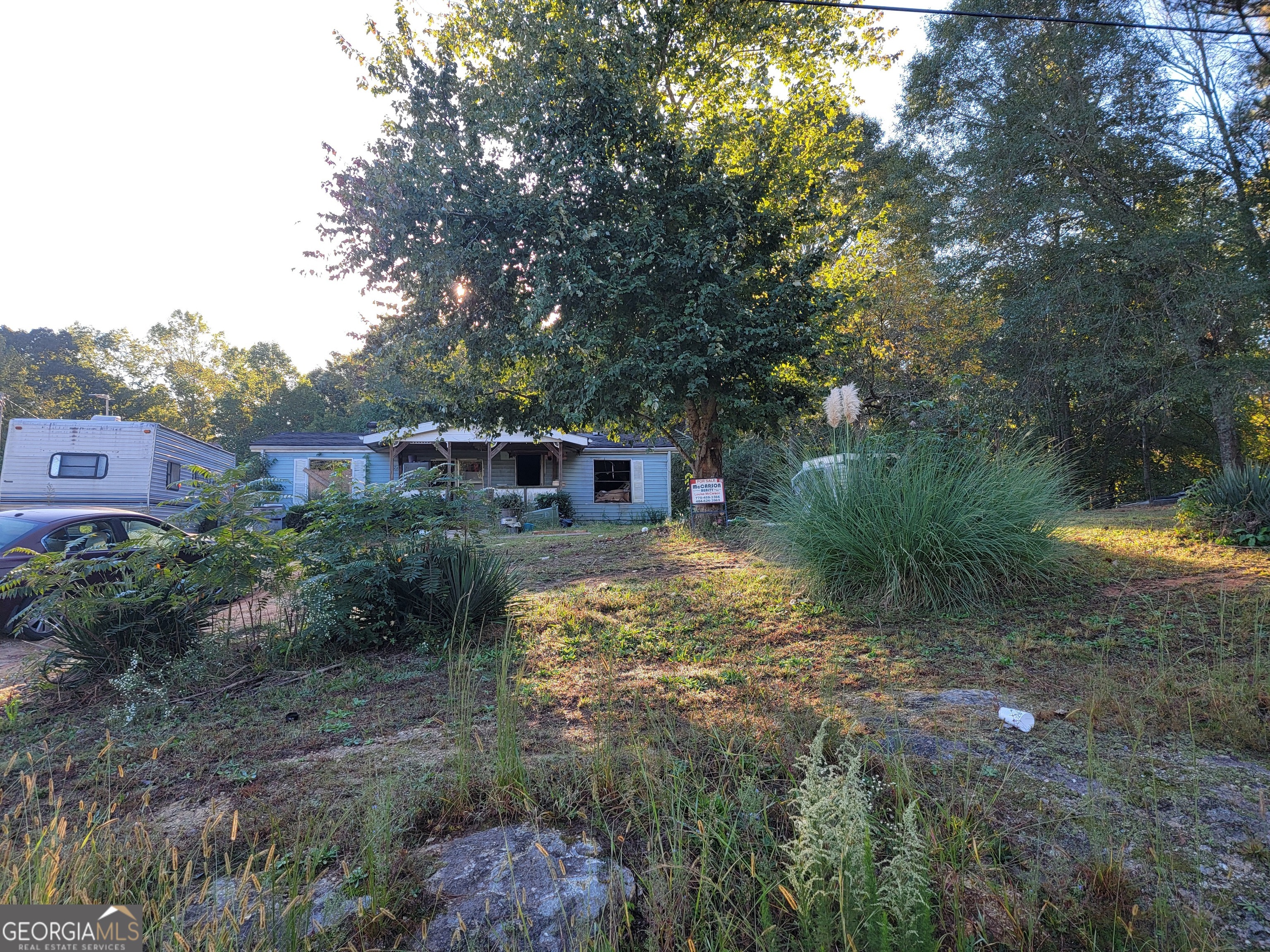 135 Price Road Carrollton, GA 30116 - Photo 1 of 1 a backyard of a house with lots of green space