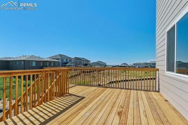 a view of balcony with wooden floor and fence