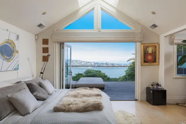 a bedroom with furniture and balcony