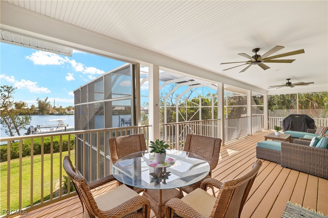 2391 Shop Road Sanibel, FL 33957 - Photo 14 of 50 a view of a patio with a dining table and chairs