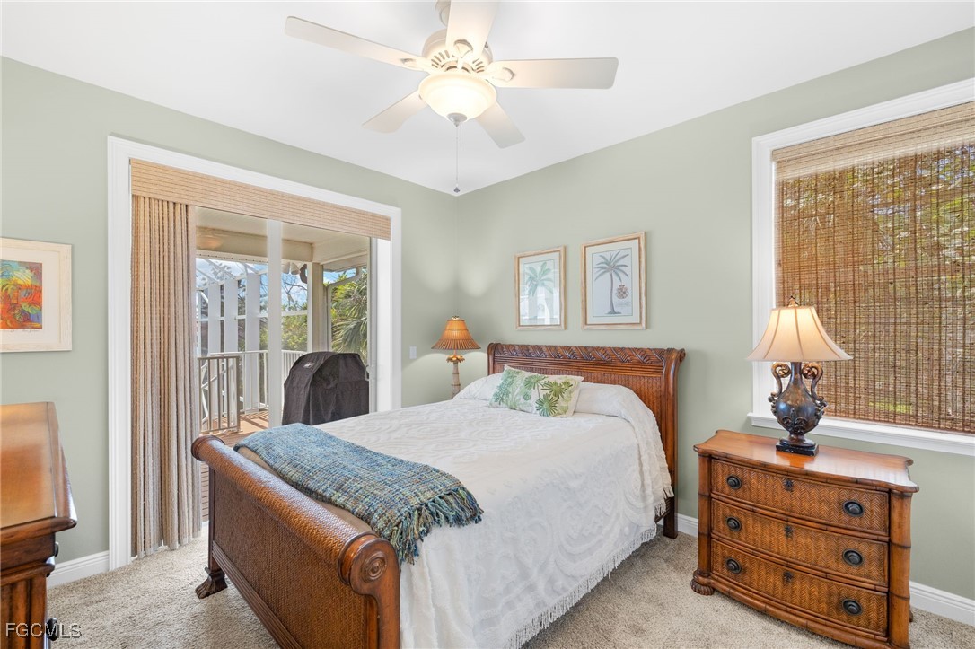 2391 Shop Road Sanibel, FL 33957 - Photo 20 of 50 a bedroom with a bed and a chandelier
