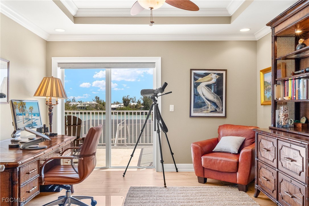 2391 Shop Road Sanibel, FL 33957 - Photo 25 of 50 a living room with furniture a bookshelf and a window