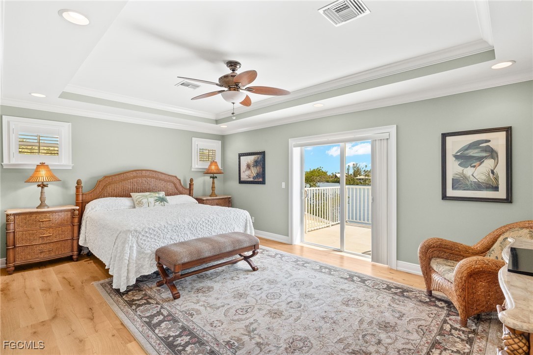 2391 Shop Road Sanibel, FL 33957 - Photo 27 of 50 a spacious bedroom with a bed a couch and a window