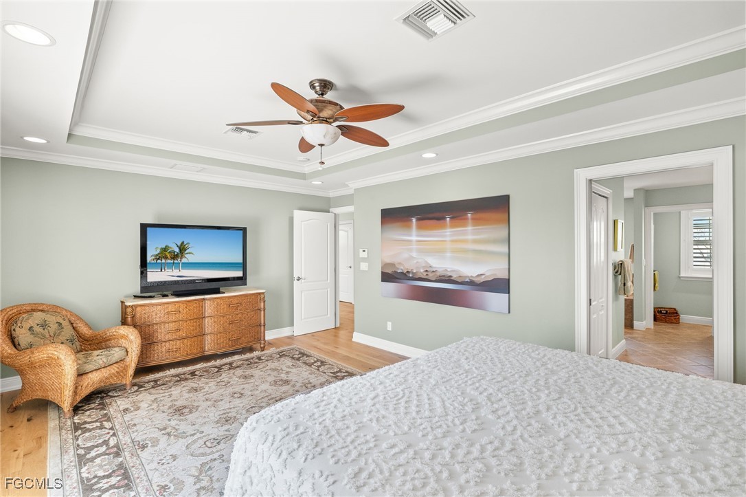 2391 Shop Road Sanibel, FL 33957 - Photo 28 of 50 a bedroom with a bed and a painting on the wall