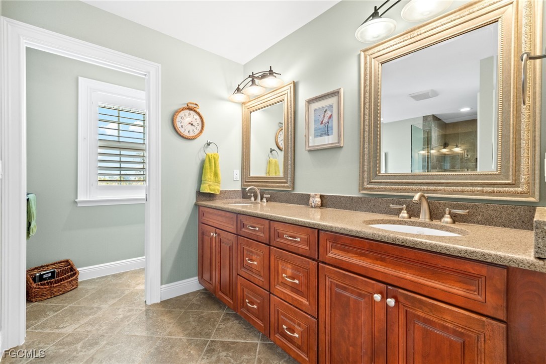 2391 Shop Road Sanibel, FL 33957 - Photo 29 of 50 a spacious bathroom with a granite countertop double vanity sink and a mirror
