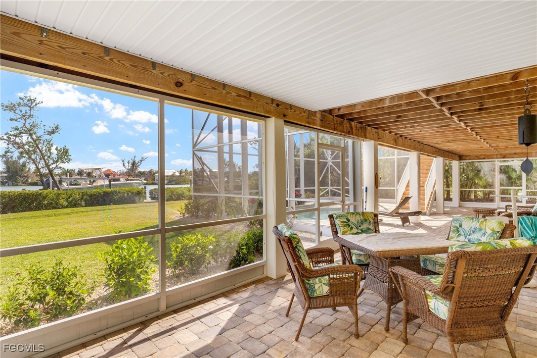 2391 Shop Road Sanibel, FL 33957 - Photo 33 of 50 a dining room with furniture and a floor to ceiling window