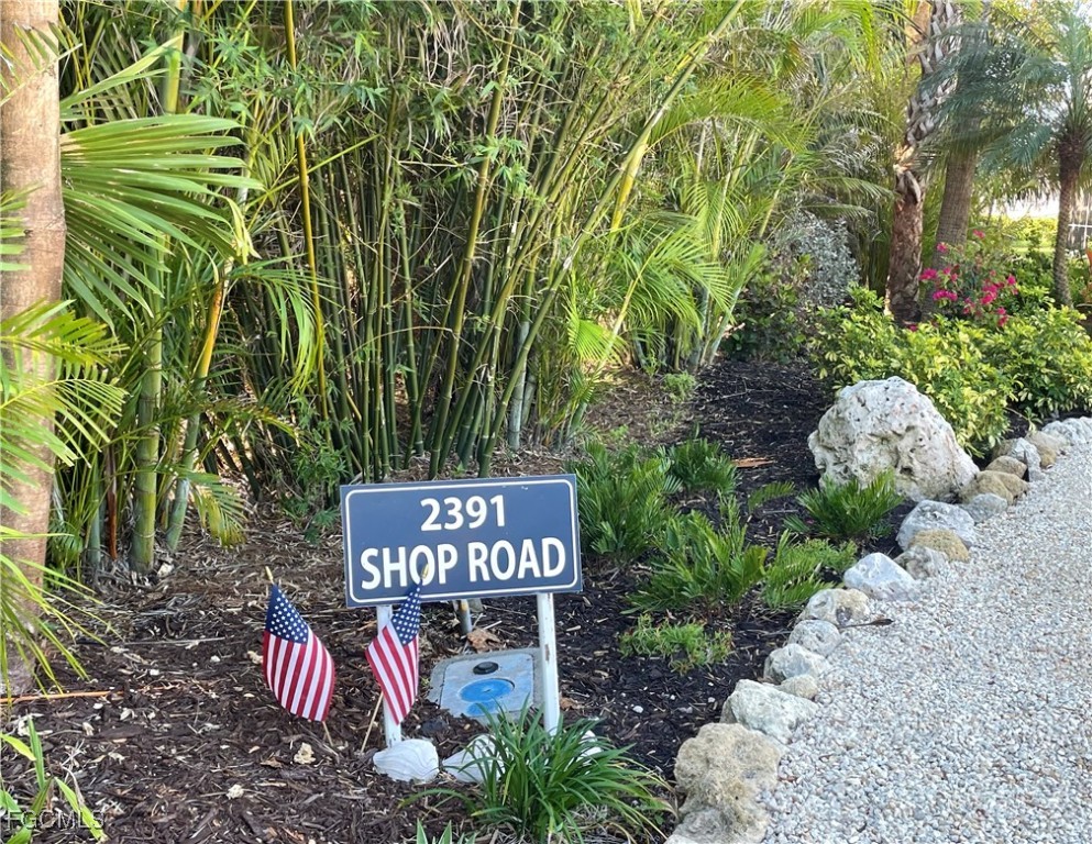 2391 Shop Road Sanibel, FL 33957 - Photo 44 of 50 a sign that is sitting in front of flowers