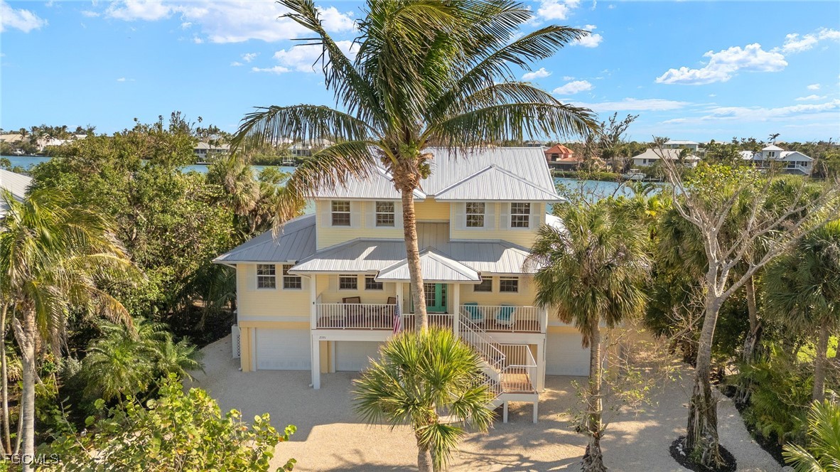 2391 Shop Road Sanibel, FL 33957 - Photo 47 of 50 a aerial view of a house with a yard and potted plants
