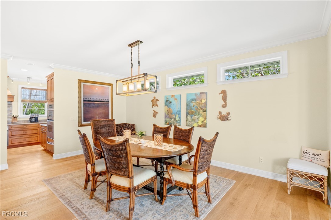 2391 Shop Road Sanibel, FL 33957 - Photo 10 of 50 a view of a dining room with furniture window and wooden floor