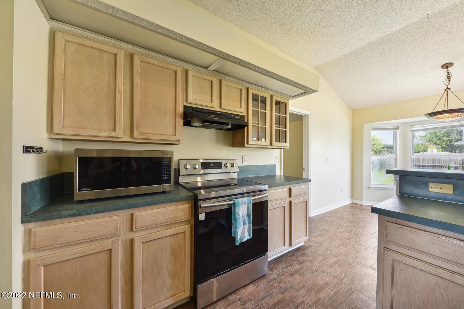 470 Federal Hill Road Orange Park, FL 32073 - Photo 13 of 26 a kitchen with stainless steel appliances granite countertop a stove and a microwave