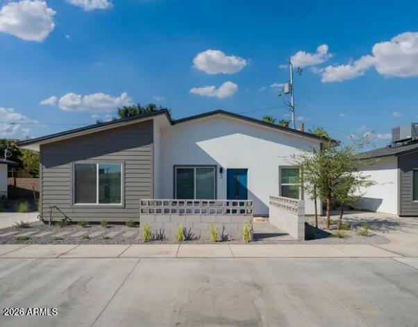 4202 North 10th Street, Unit 6 Phoenix, AZ 85014 - Photo 13 of 18 a front view of a house with a yard and garage