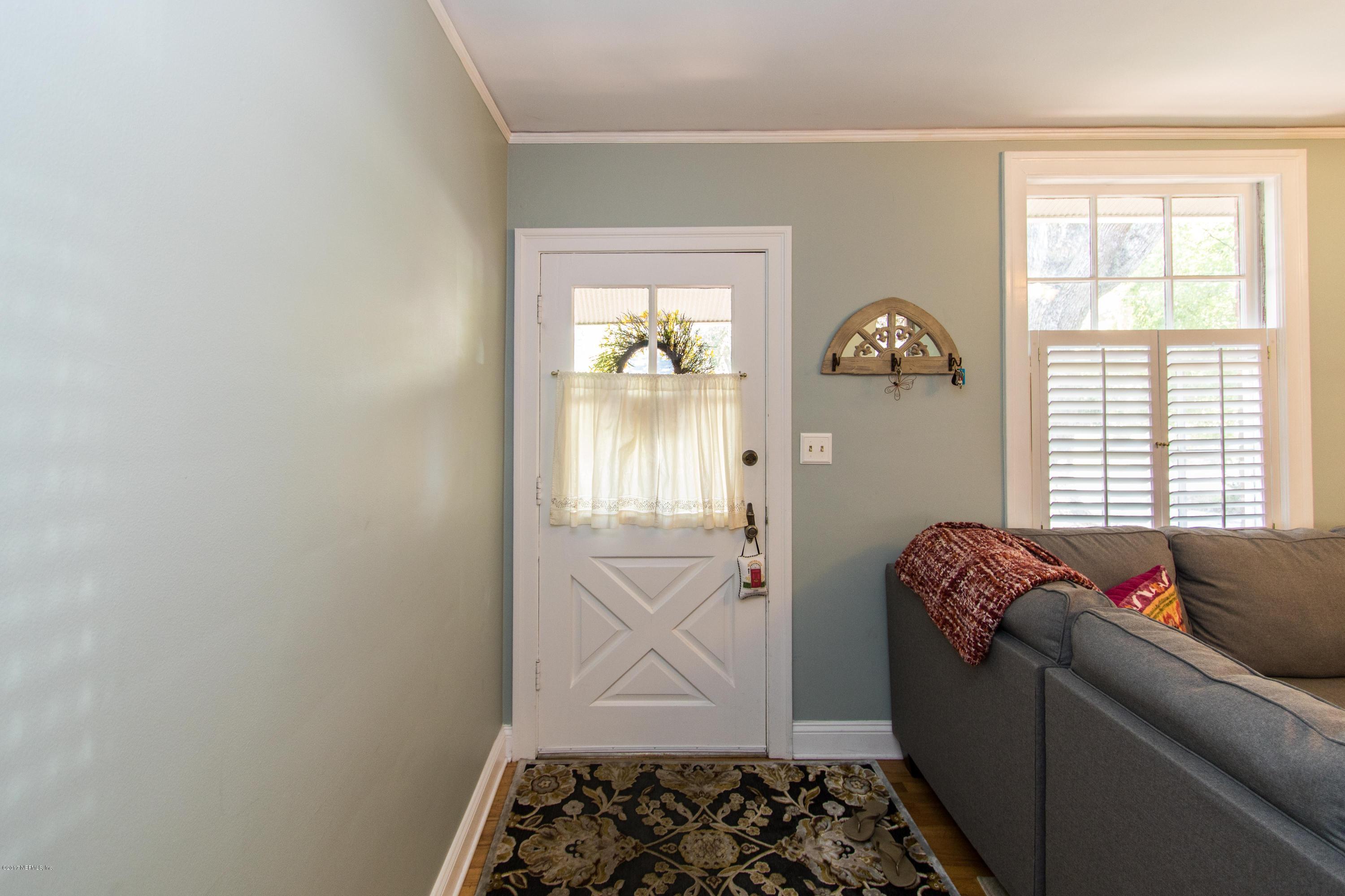 2144 Huntsford Road Jacksonville, FL 32207 - Photo 8 of 39 a room with window and walk in closet with wooden floor