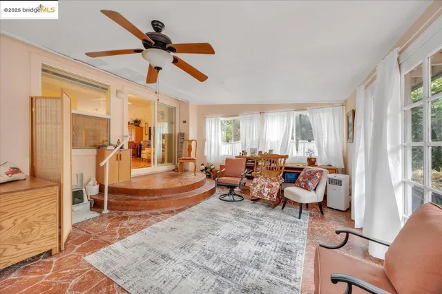 a living room with furniture and a large window