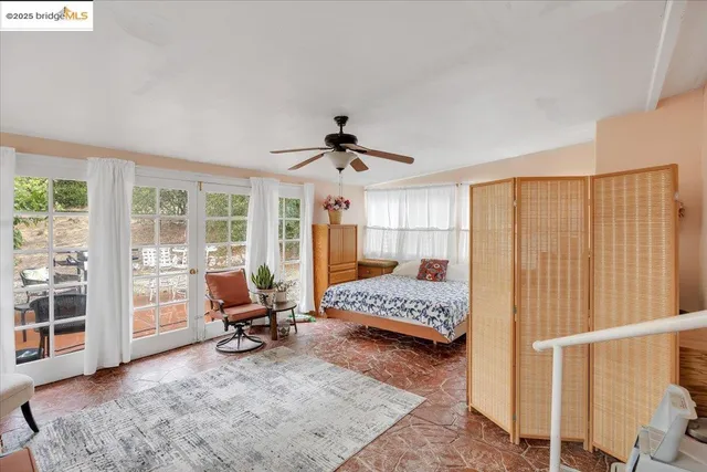 a view of a livingroom with workspace and a window