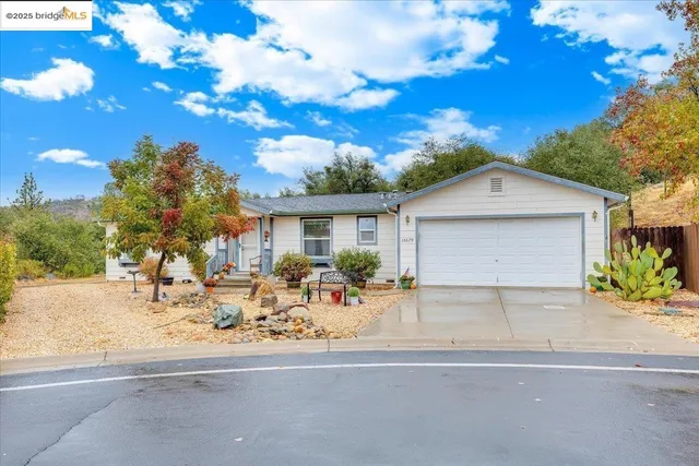 a group of people sitting in front of a house