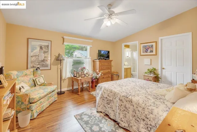 a spacious bedroom with a large bed a chandelier and a couch